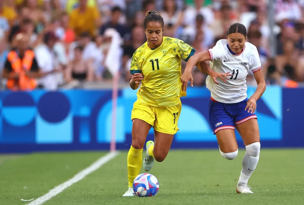 two girls playing football
